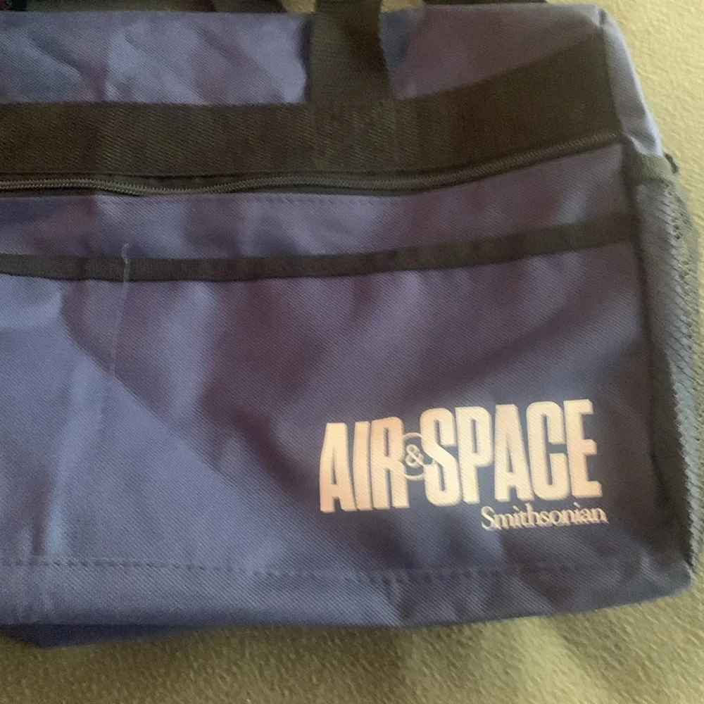 Smithsonian Air & Space blue and black duffel bag. Approx 17” x 9” x 7 1/4”
